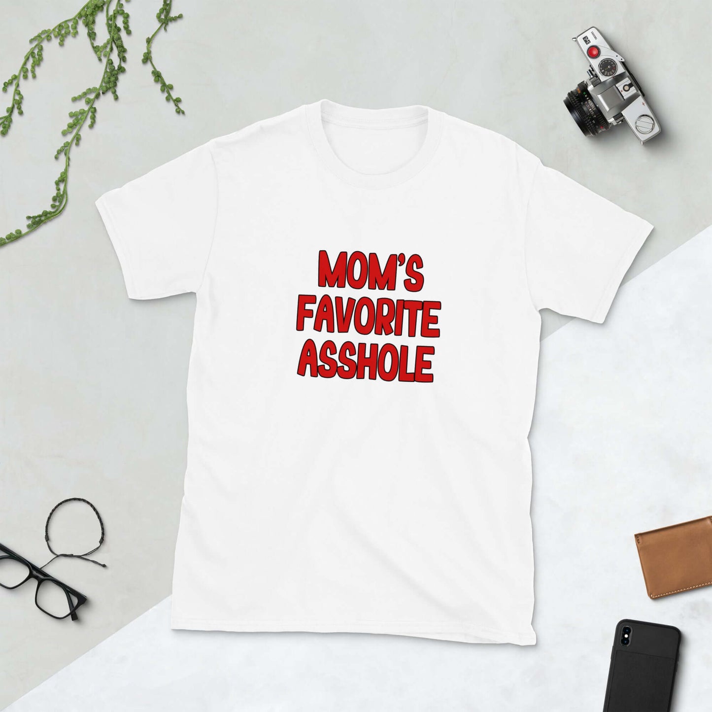 White t-shirt with the words Mom's favorite asshole printed in red on the front. 