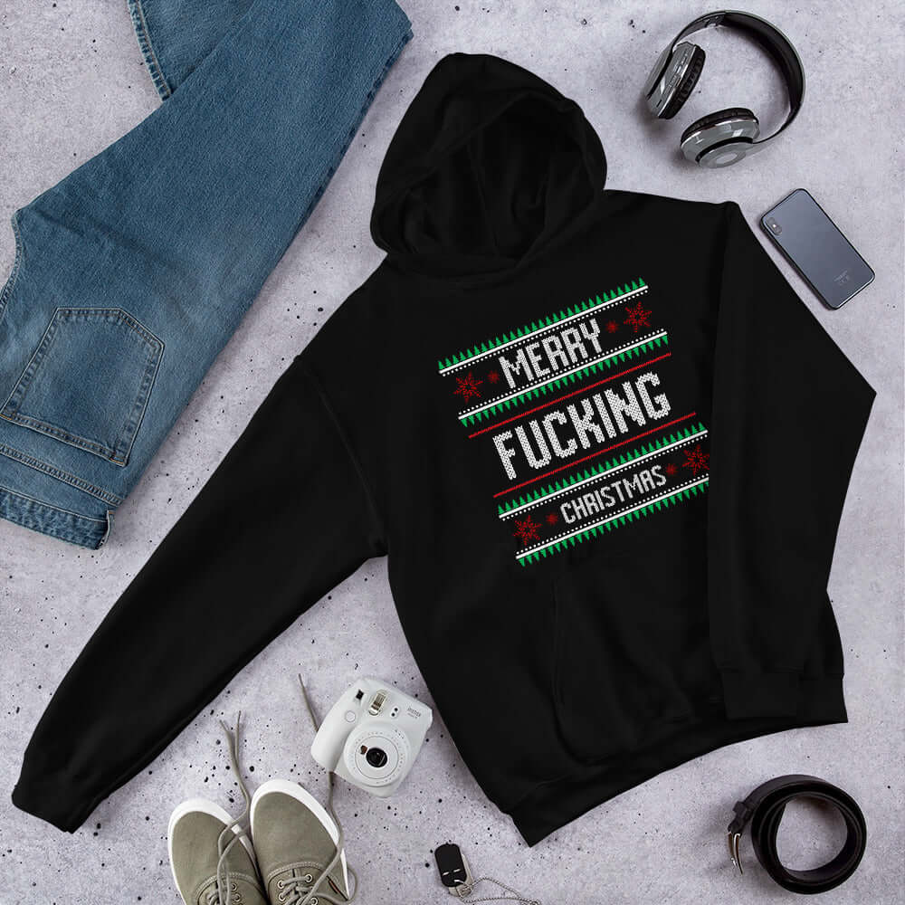 Black hoodie sweatshirt with the phrase Merry fucking Christmas printed on the front in sweater print font.