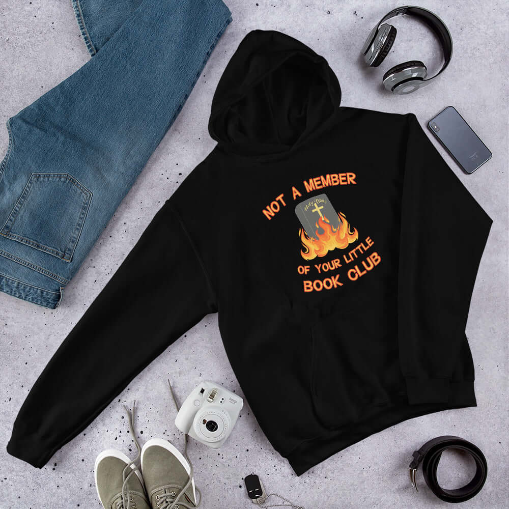 Black hoodie sweatshirt with image of a burning bible and the words Not a member of your little book club printed on the front.