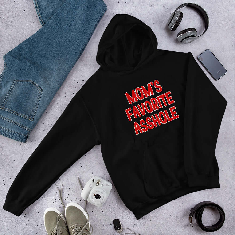 Black hooded sweatshirt with the words Mom's favorite asshole printed in red on the front. 