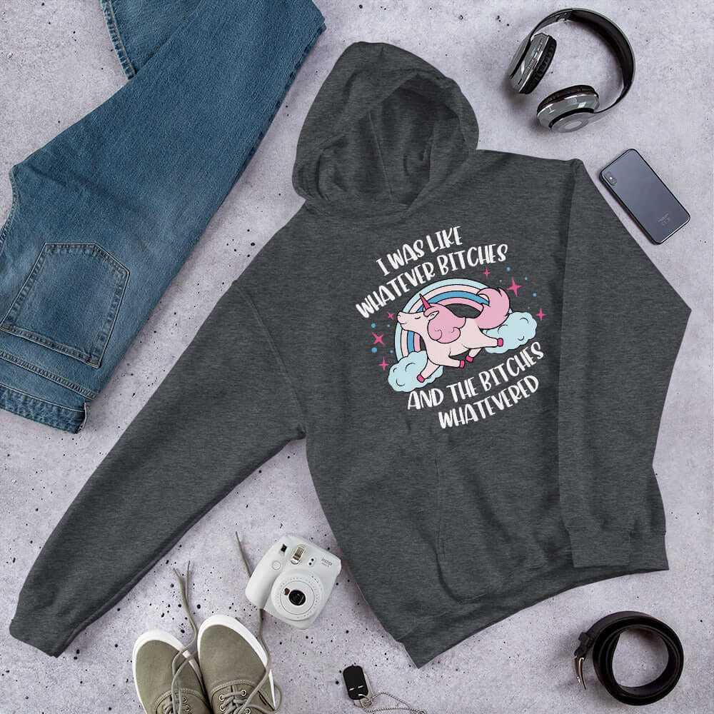 Dark heather grey hoodie sweatshirt with a prancing unicorn rainbow graphic. The phrase I was like whatever bitches and the bitches whatevered printed on the front.