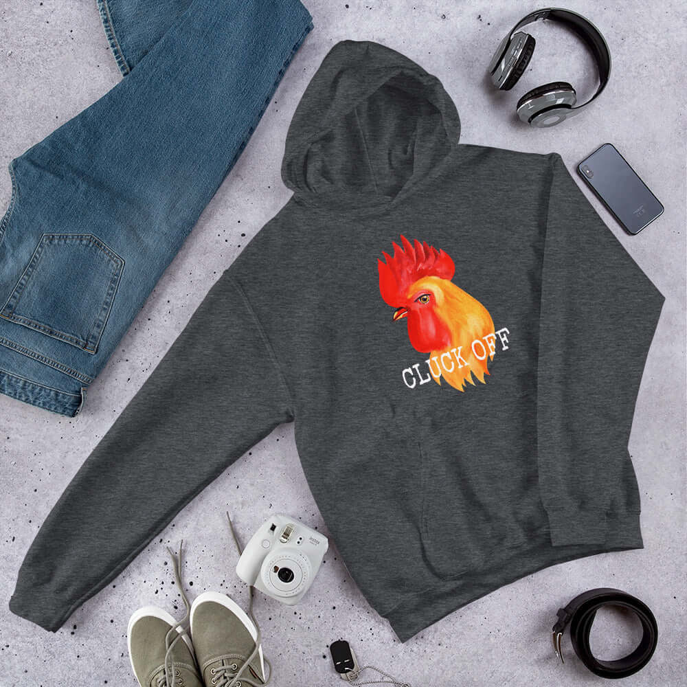 Dark heather grey pun hoodie sweatshirt that has graphic of a chicken and the words Cluck off printed on the front.