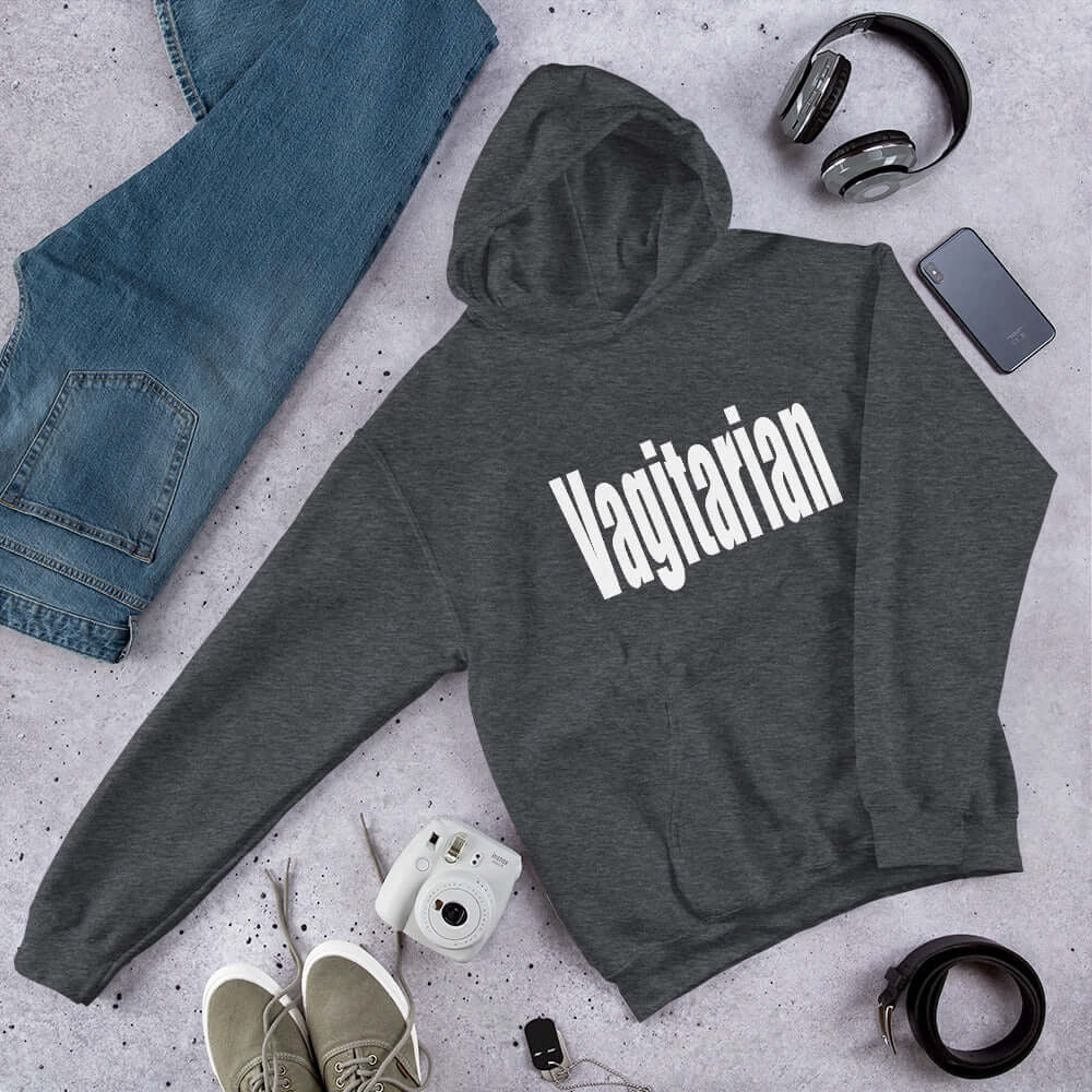 Dark heather grey hoodie sweatshirt with the word Vagitarian printed on the front.