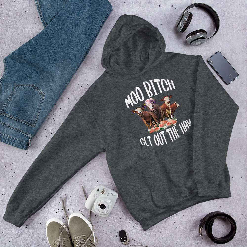 Dark heather grey hoodie sweatshirt with an image of 3 cows and the words Moo bitch get out the hay printed on the front.