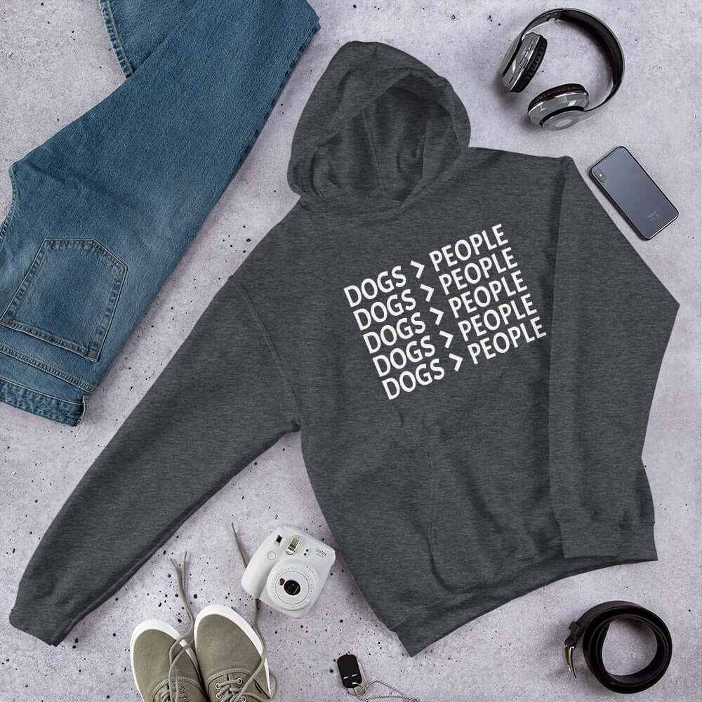 Dark grey hoodie sweatshirt with the words Dogs > people printed on the front.