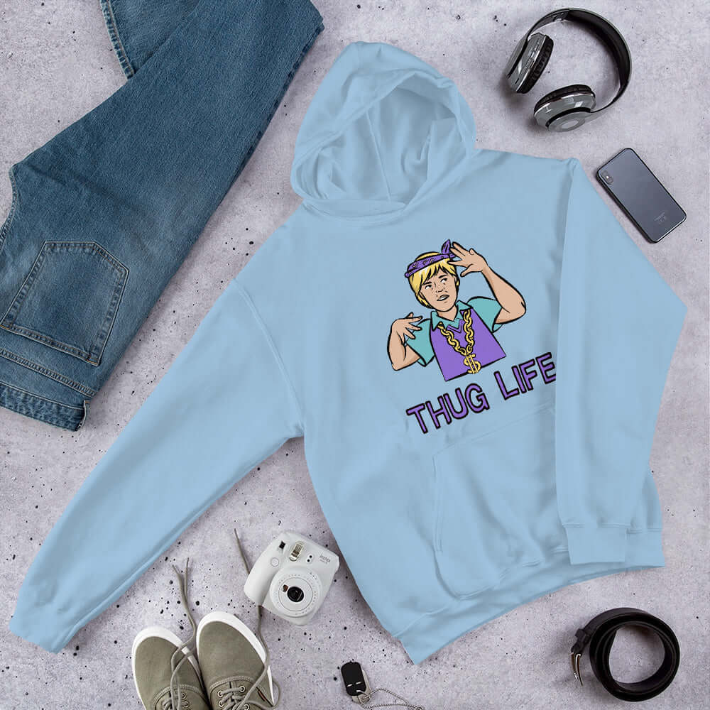 Light blue hoodie sweatshirt with a parody image of a blond haired child trying to be a gangster with the words Thug Life printed on the front.