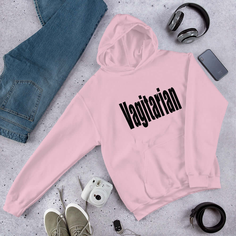 Light pink hoodie sweatshirt with the word Vagitarian printed on the front.