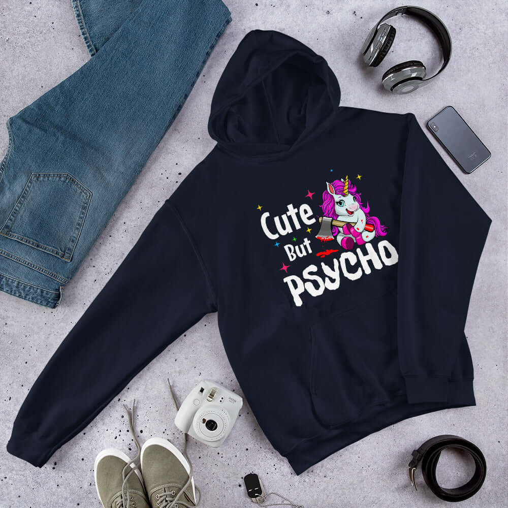 Navy blue hoodie sweatshirt with a graphic of a unicorn holding a knife & the words Cute but psycho printed on the front.