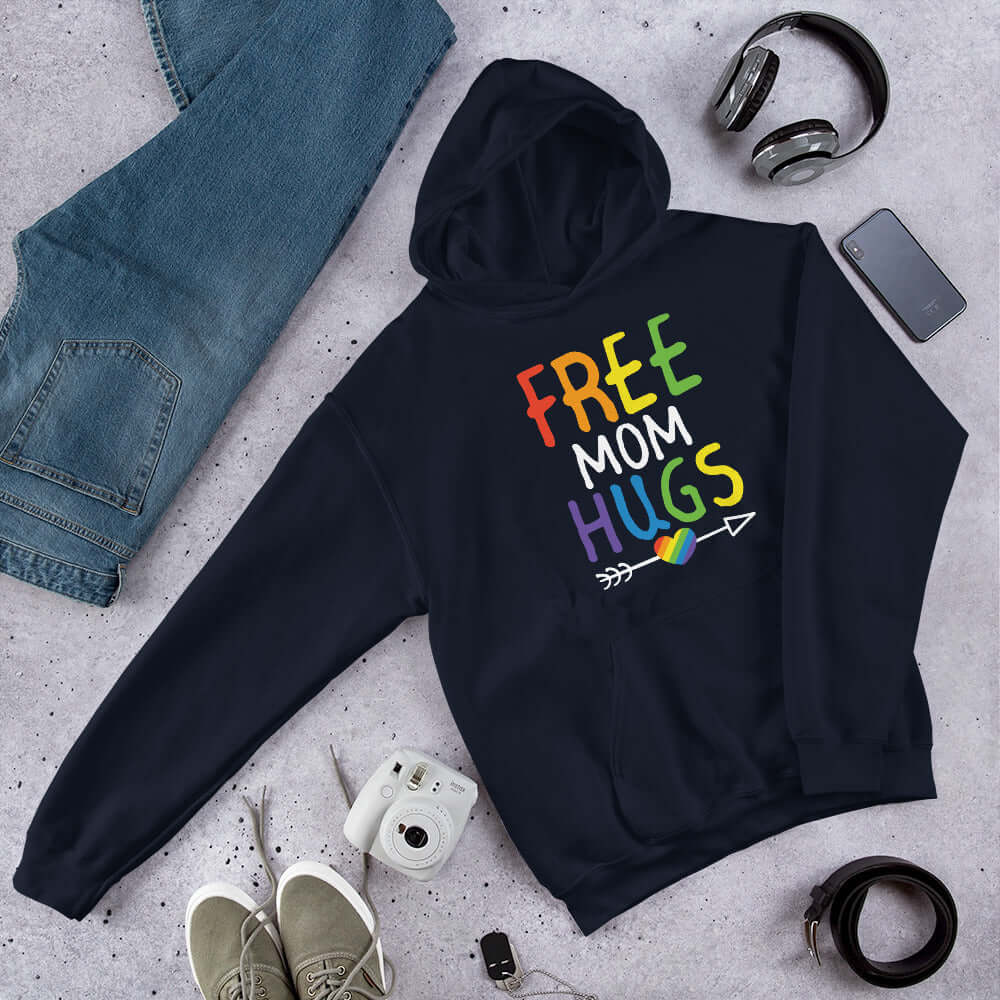 Navy blue hooded sweatshirt with the words Free Mom hugs in rainbow lettering printed on the front.