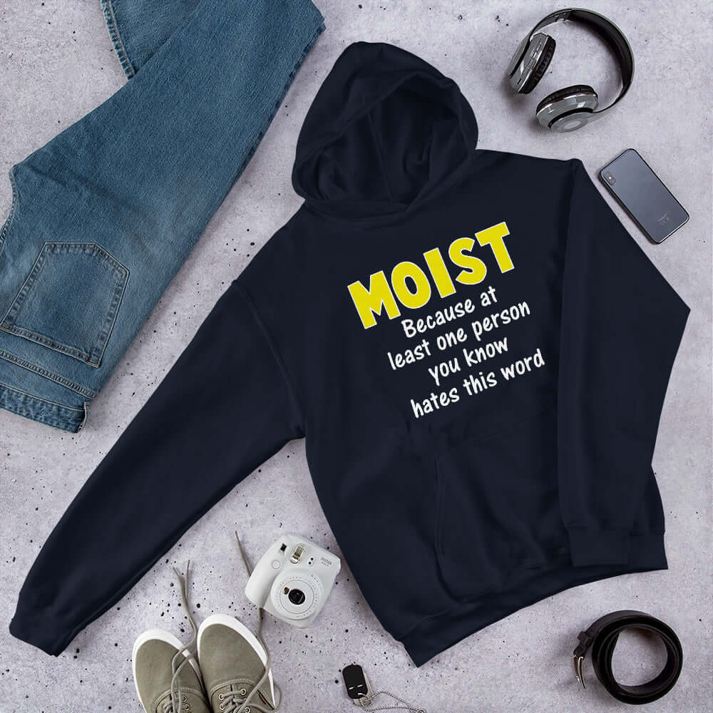 Navy blue hoodie sweatshirt with the word Moist printed in large yellow bold font. In smaller font under the word moist is the phrase Because at least one person you know hates this word. 