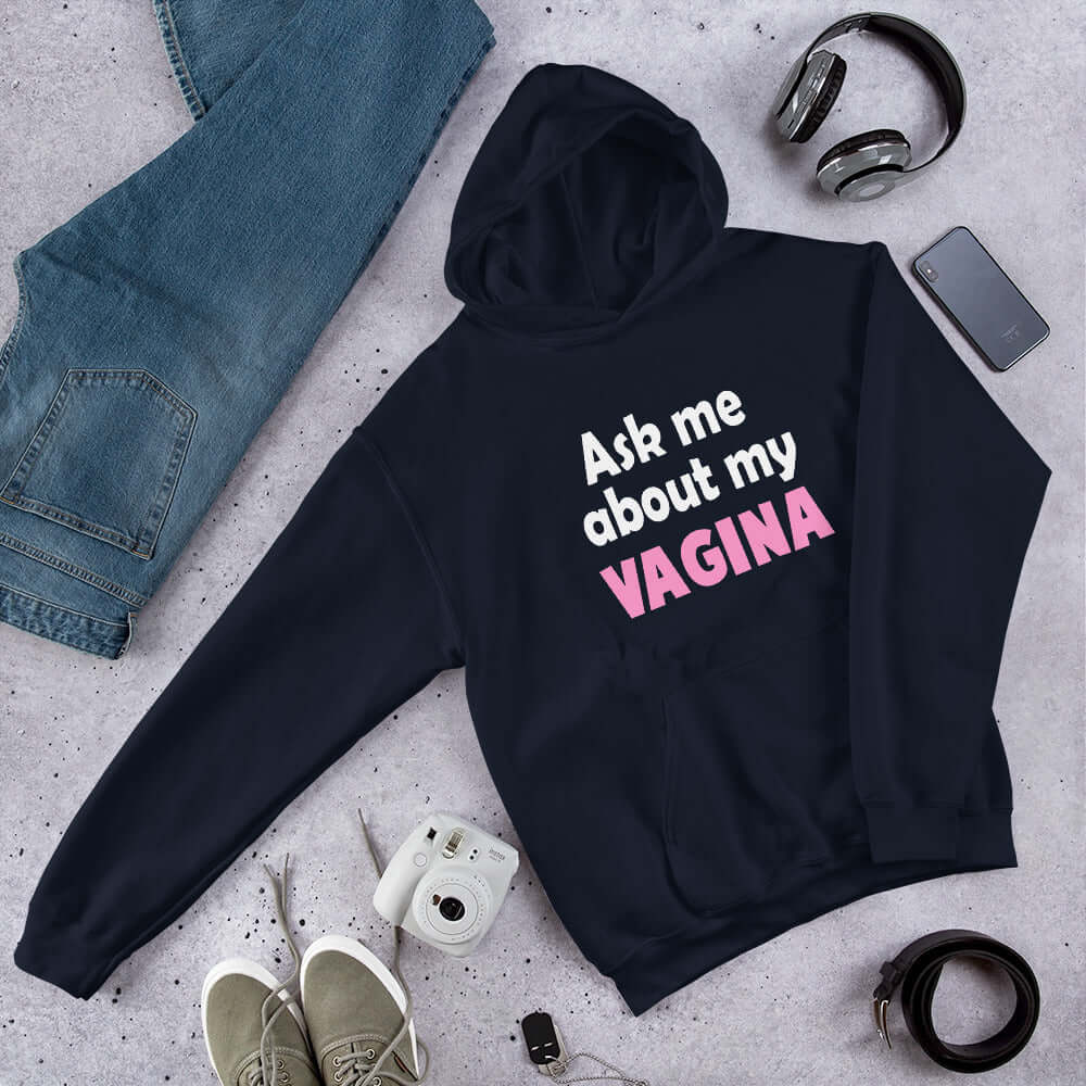Navy blue hoodie sweatshirt with the words Ask me about my vagina printed on the front. The word vagina is printed in pink. The rest of the text is white.