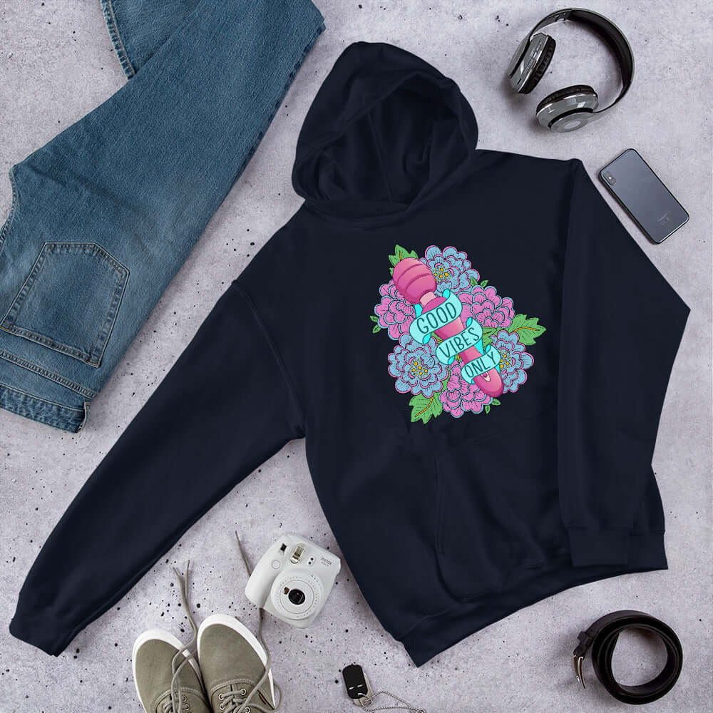 Navy blue hoodie sweatshirt with graphic design that has the words Good vibes only layered over a pink wand vibrator with flowers around. The graphic design is printed on the front of the hoodie.