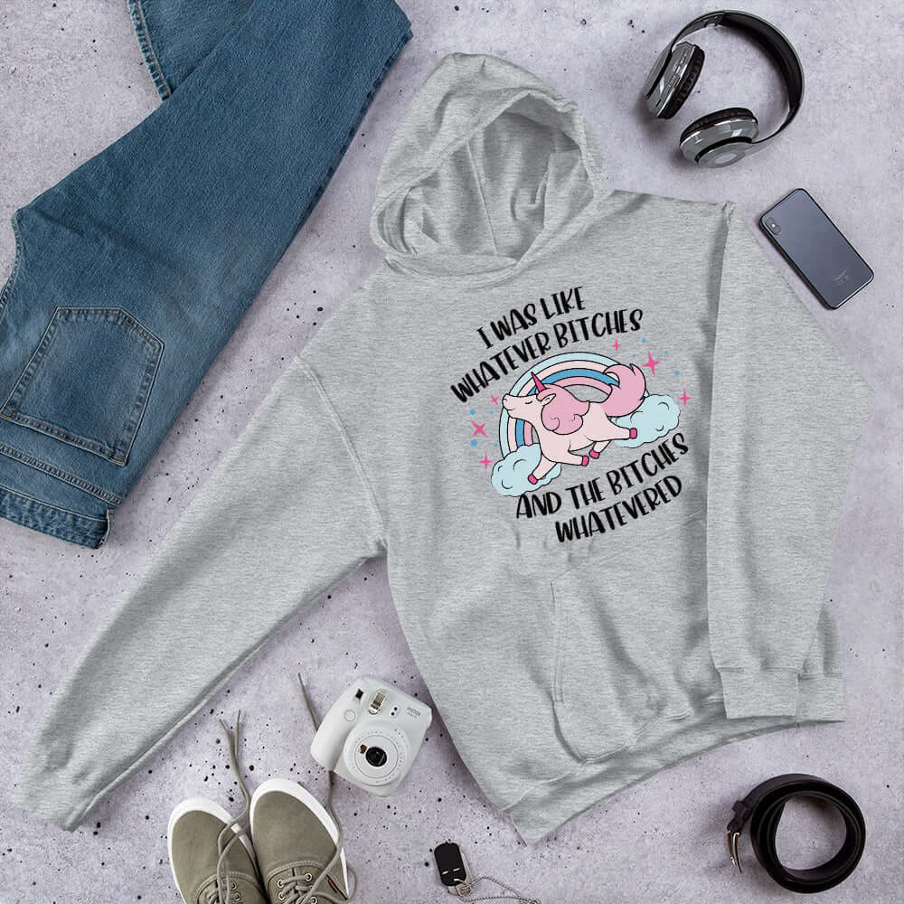 Light grey hoodie sweatshirt with a prancing unicorn rainbow graphic. The phrase I was like whatever bitches and the bitches whatevered printed on the front.