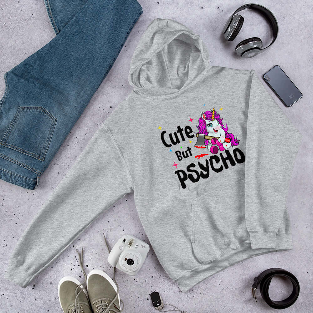 Light grey hoodie sweatshirt with a graphic of a unicorn holding a knife & the words Cute but psycho printed on the front.