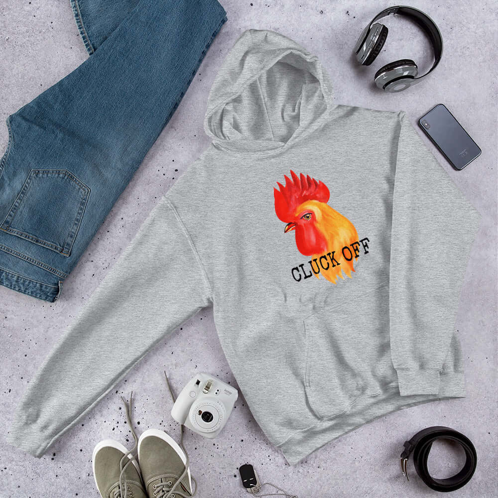 Light grey pun hoodie sweatshirt that has graphic of a chicken and the words Cluck off printed on the front.