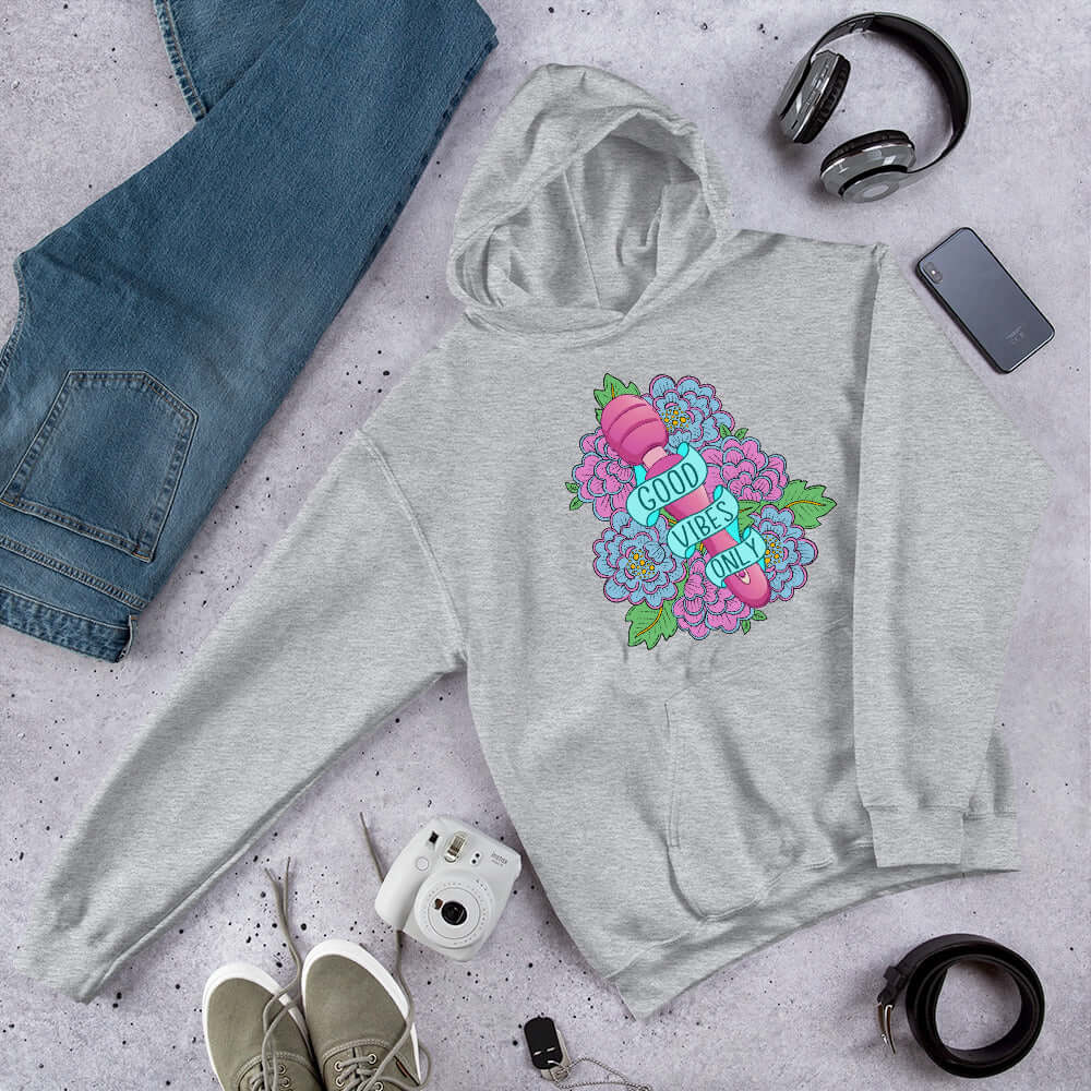 Light grey hoodie sweatshirt with graphic design that has the words Good vibes only layered over a pink wand vibrator with flowers around. The graphic design is printed on the front of the hoodie.