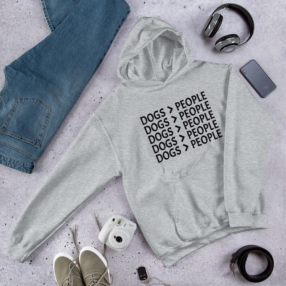 Light grey hoodie sweatshirt with the words Dogs > people printed on the front.
