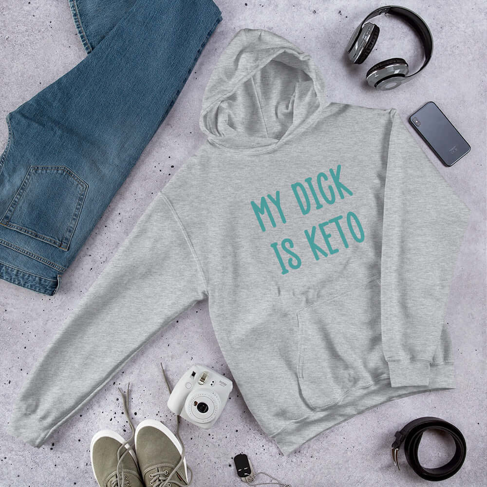 Light grey hoodie sweatshirt with the phrase My dick is keto printed on the front in turquoise font.