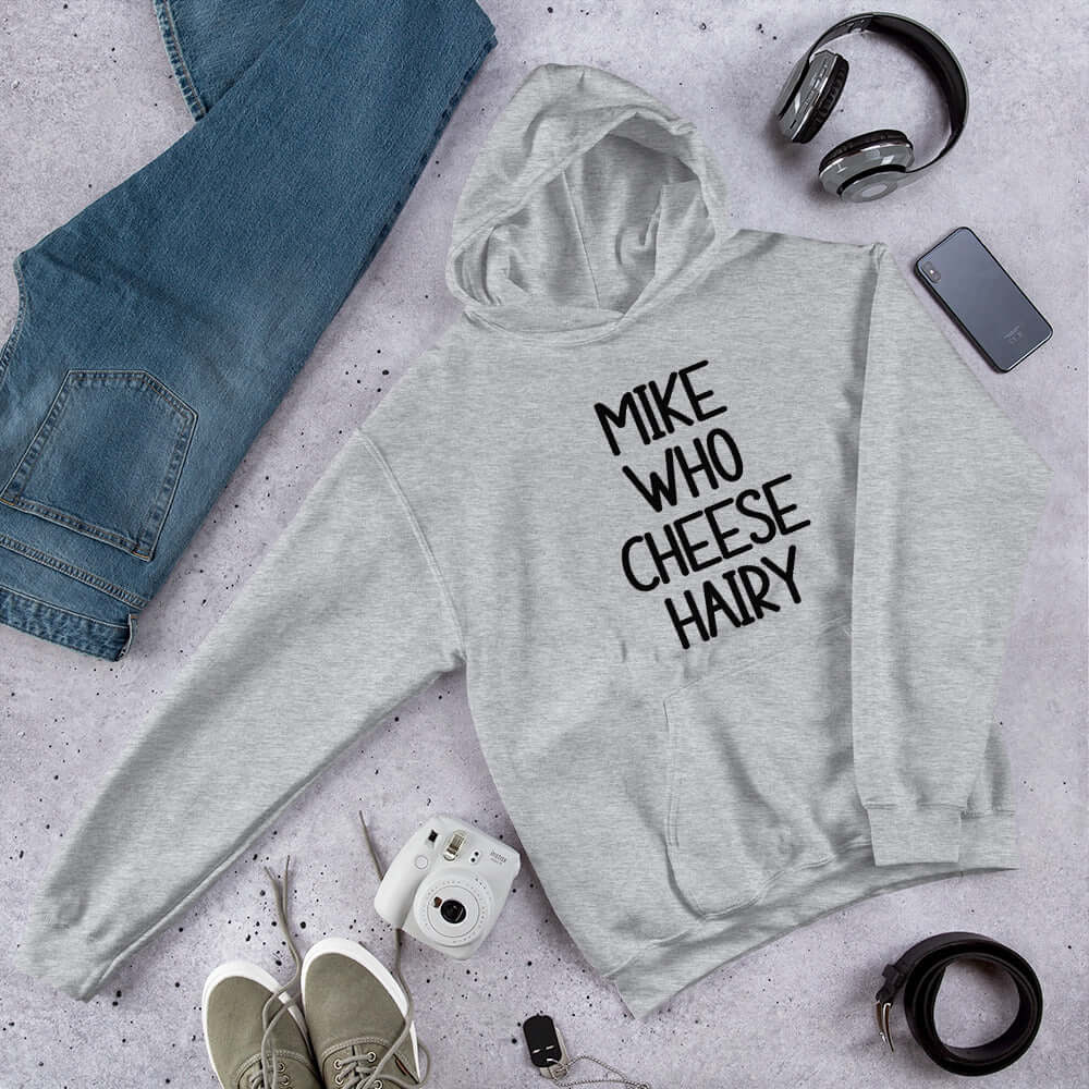 Light grey pun hoodie sweatshirt with the words Mike who cheese hairy printed on the front.