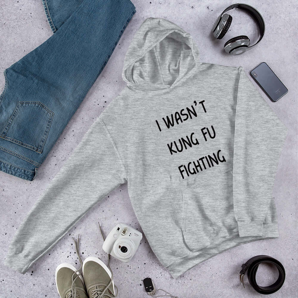 Grey hoodie sweatshirt with the funny phrase I wasn't kung fu fighting printed on the front.