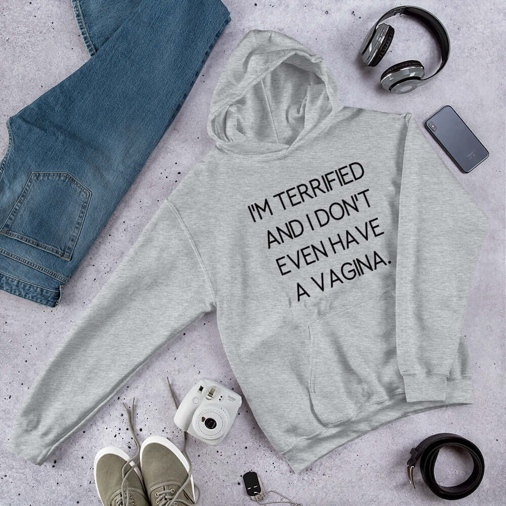 Light grey hoodie sweatshirt with the words I'm terrified and I don't even have a vagina printed on the front.