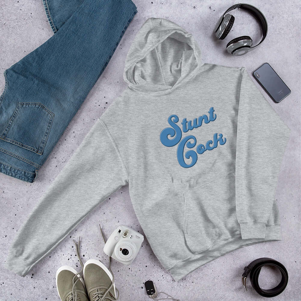 Light grey hooded sweatshirt with the words Stunt Cock printed on the front in blue.