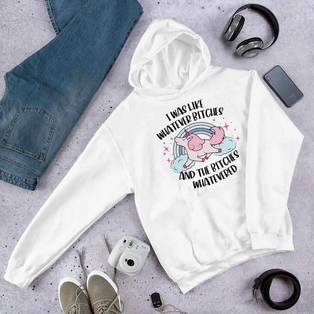 White hoodie sweatshirt with a prancing unicorn rainbow graphic. The phrase I was like whatever bitches and the bitches whatevered printed on the front.