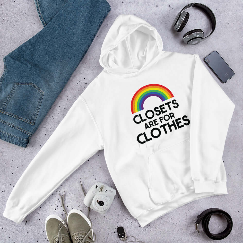 White hoodie sweatshirt with a rainbow and the words Clothes are for closets printed on the front.