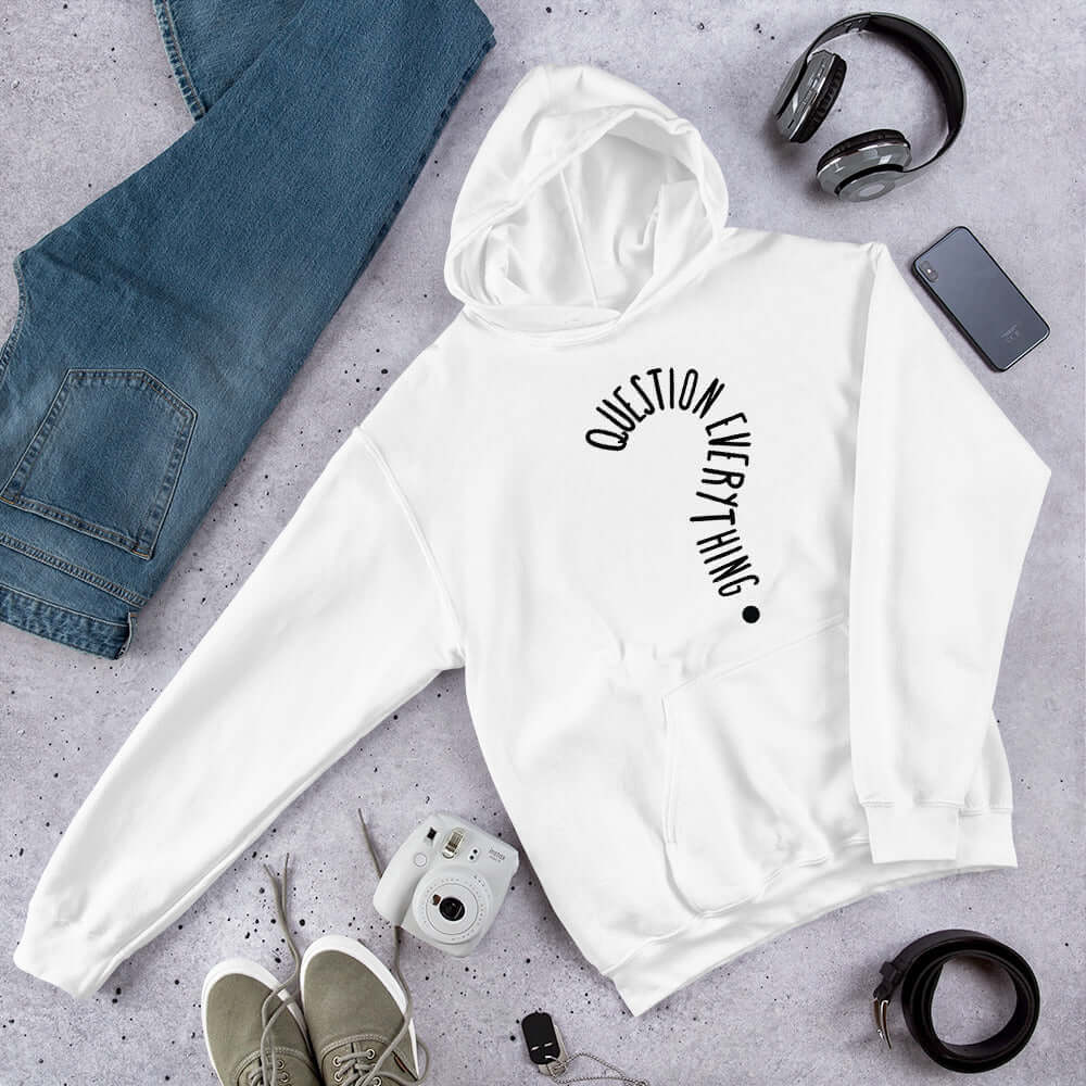 White hoodie sweatshirt with the words Question everything printed on the front. The words are in the shape of a question mark.