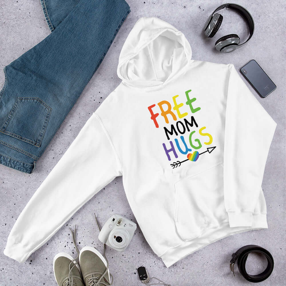 White hooded sweatshirt with the words Free Mom hugs in rainbow lettering printed on the front.