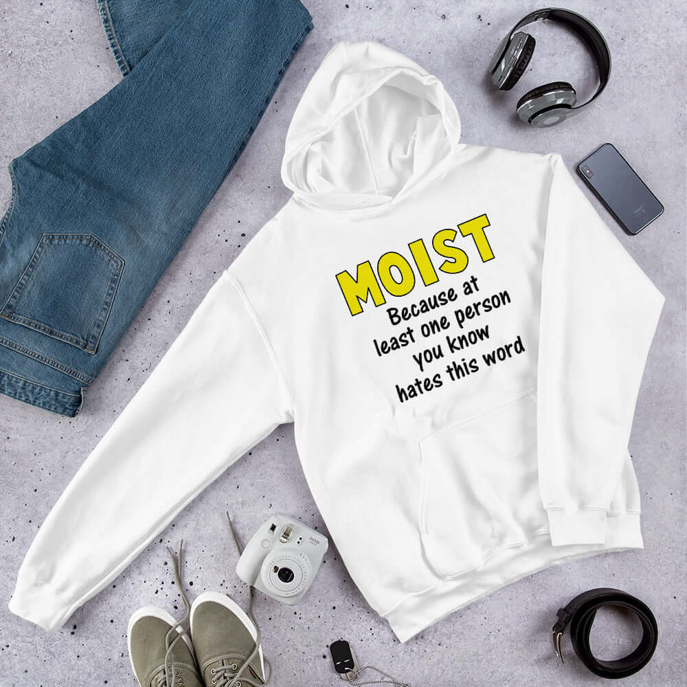 White hoodie sweatshirt with the word Moist printed in large yellow bold font. In smaller font under the word moist is the phrase Because at least one person you know hates this word. 