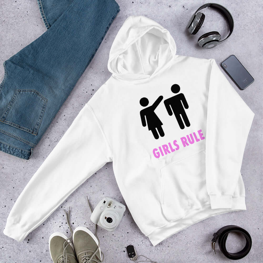 White hoodie sweatshirt. The sweatshirt has an image of a stick figure man and woman. The woman is punching the mans head off and the words Girls rule is printed beneath in hot pink. The graphics are printed on the front of the hoodie.