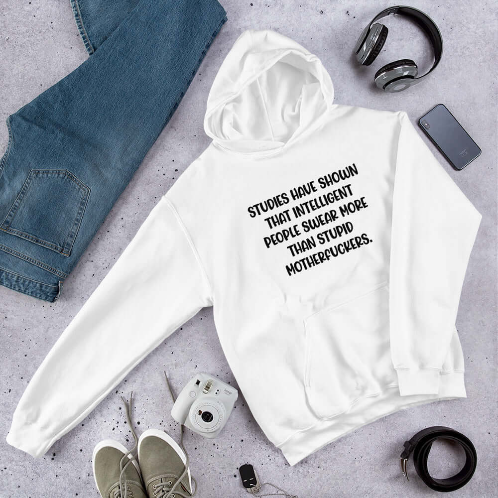White hoodie sweatshirt with the funny phrase Studies have shown that intelligent people swear more than stupid motherfuckers printed on the front.