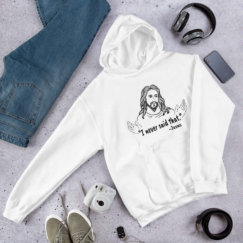 White hoodie sweatshirt with a line drawing of Jesus with his hands outstretched and the quote I never said that printed on the front.