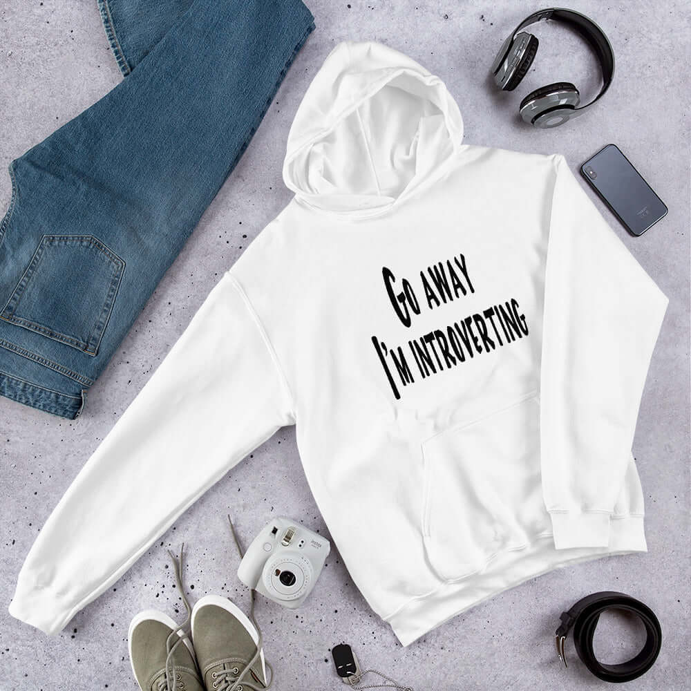 White hoodie sweatshirt with the phrase Go away, I'm introverting printed on the front.