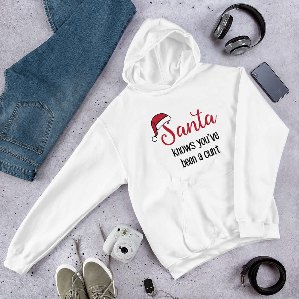 White hoodie sweatshirt with the words Santa knows you've been a cunt printed on the front. There is a Santa hat on the s in Santa.