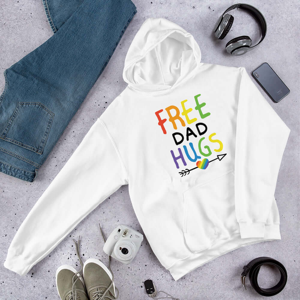 White hoodie sweatshirt with the words Free Dad hugs printed on the front in rainbow letters.