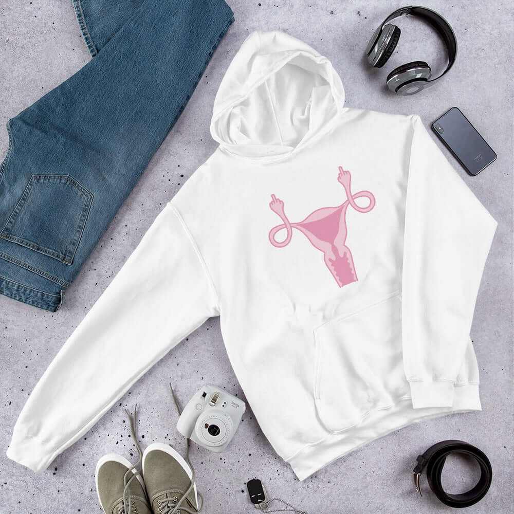 white hoodie sweatshirt with pink uterus flipping middle finger graphic printed on it by witticisms r us dot com