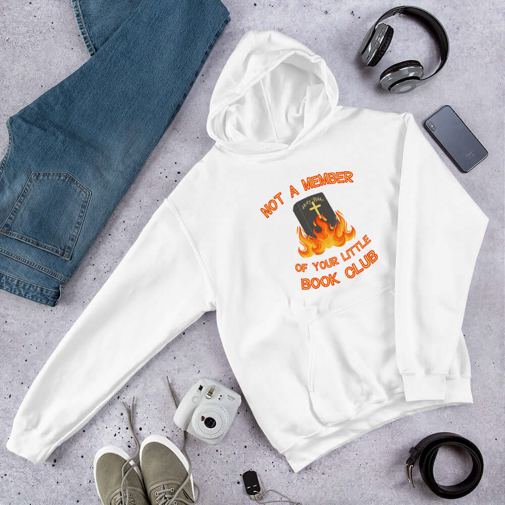 White hoodie sweatshirt with image of a burning bible and the words Not a member of your little book club printed on the front.