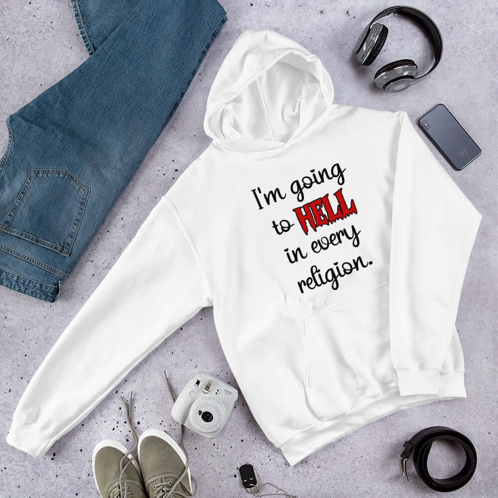 White hoodie sweatshirt with the phrase I'm going to hell in every religion printed on the front. The word hell is printed in red. The rest of the text is black.