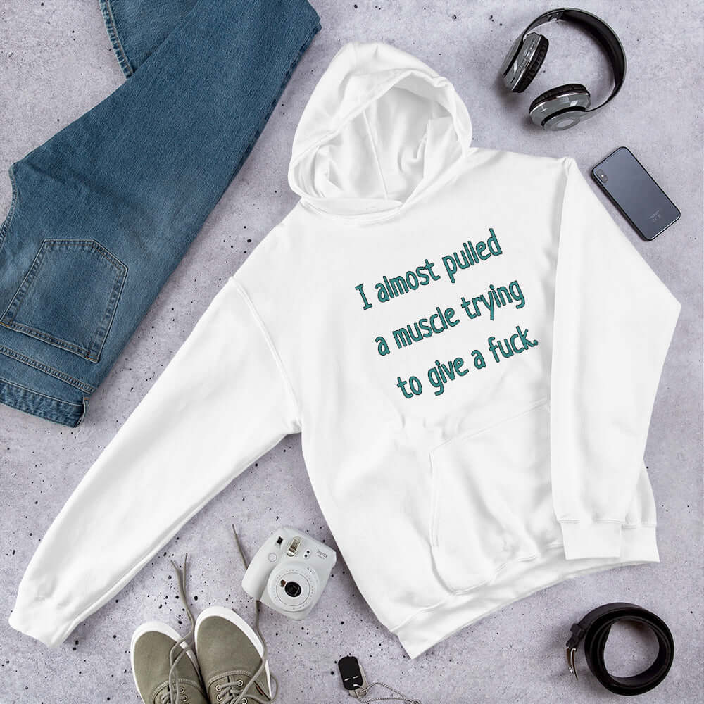 White hooded sweatshirt with the words I Almost pulled a muscle trying to give a fuck printed on the front.