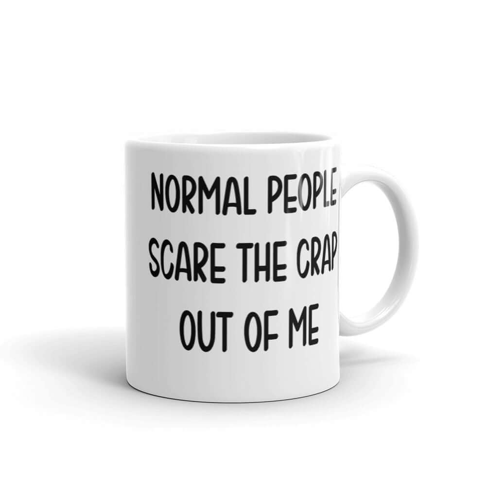 White ceramic coffee mug with the phrase Normal people scare the crap out of me printed on both sides.