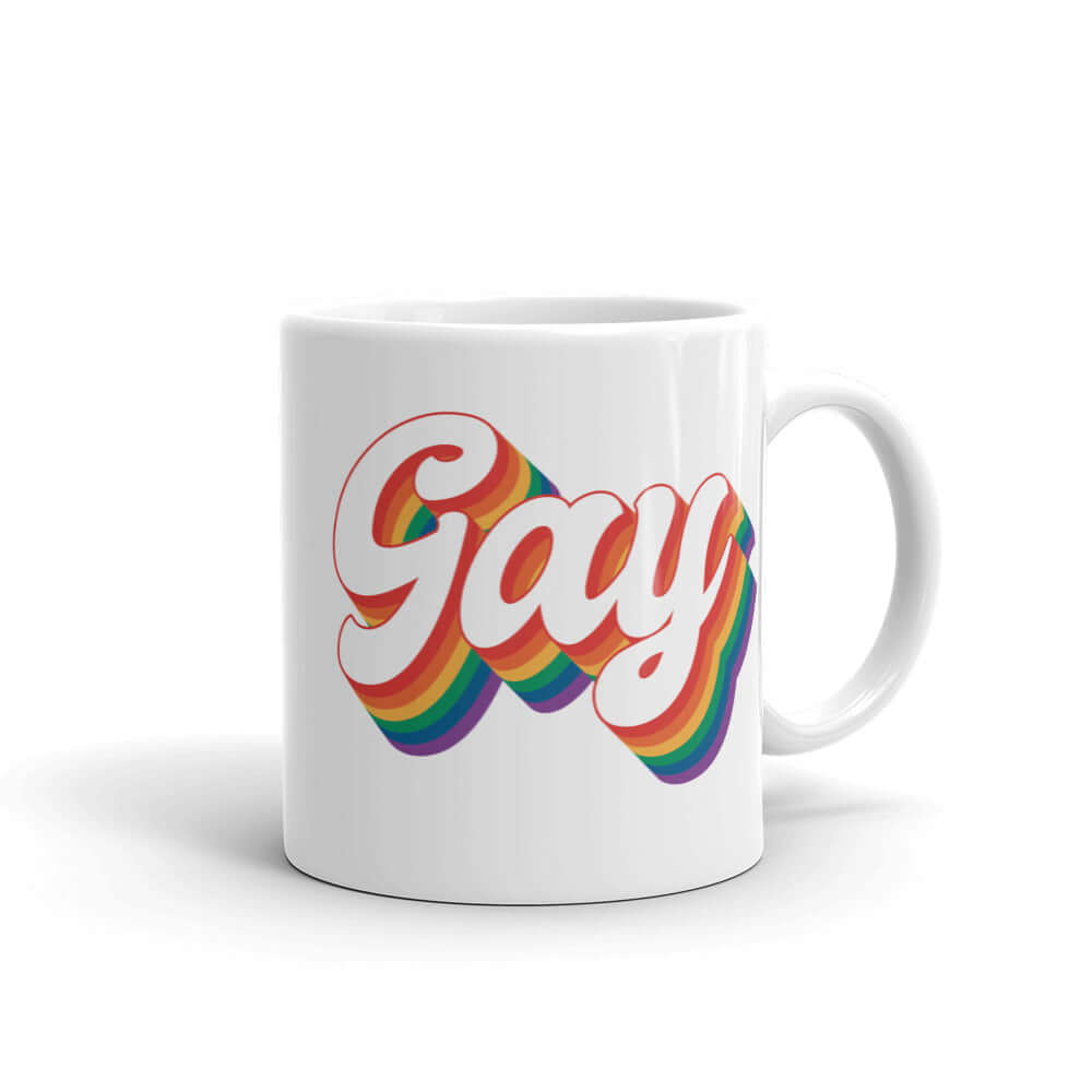 White ceramic mug with the word Gay printed on both sides. The word gay is outlined in rainbow.