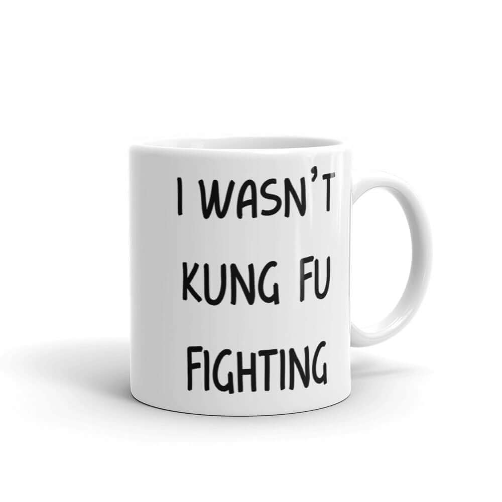 White ceramic coffee mug with the funny phrase I wasn't kung fu fighting printed on both sides.