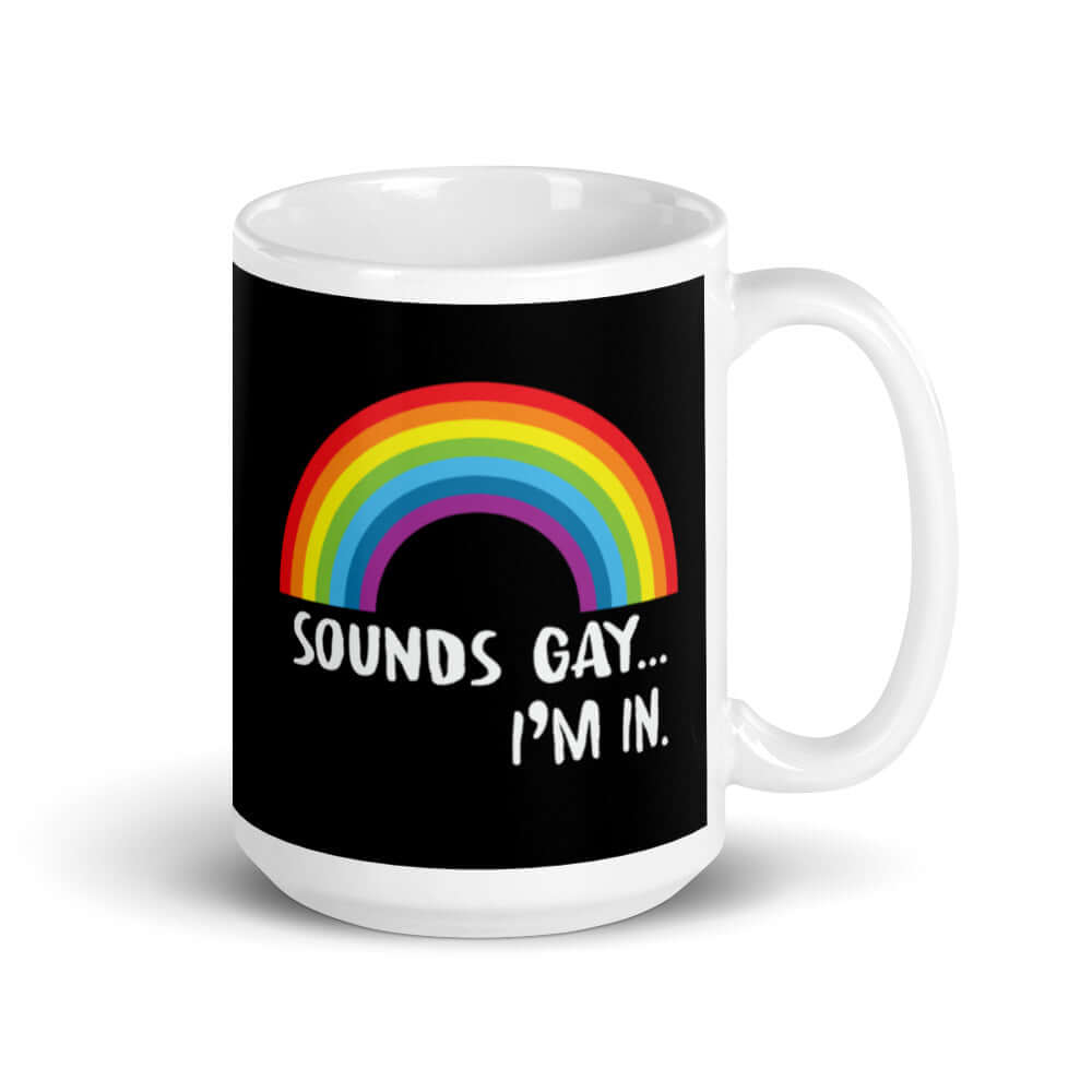 Black and white ceramic coffee mug that has an image of a rainbow and the phrase Sounds gay, I'm in printed on both sides.