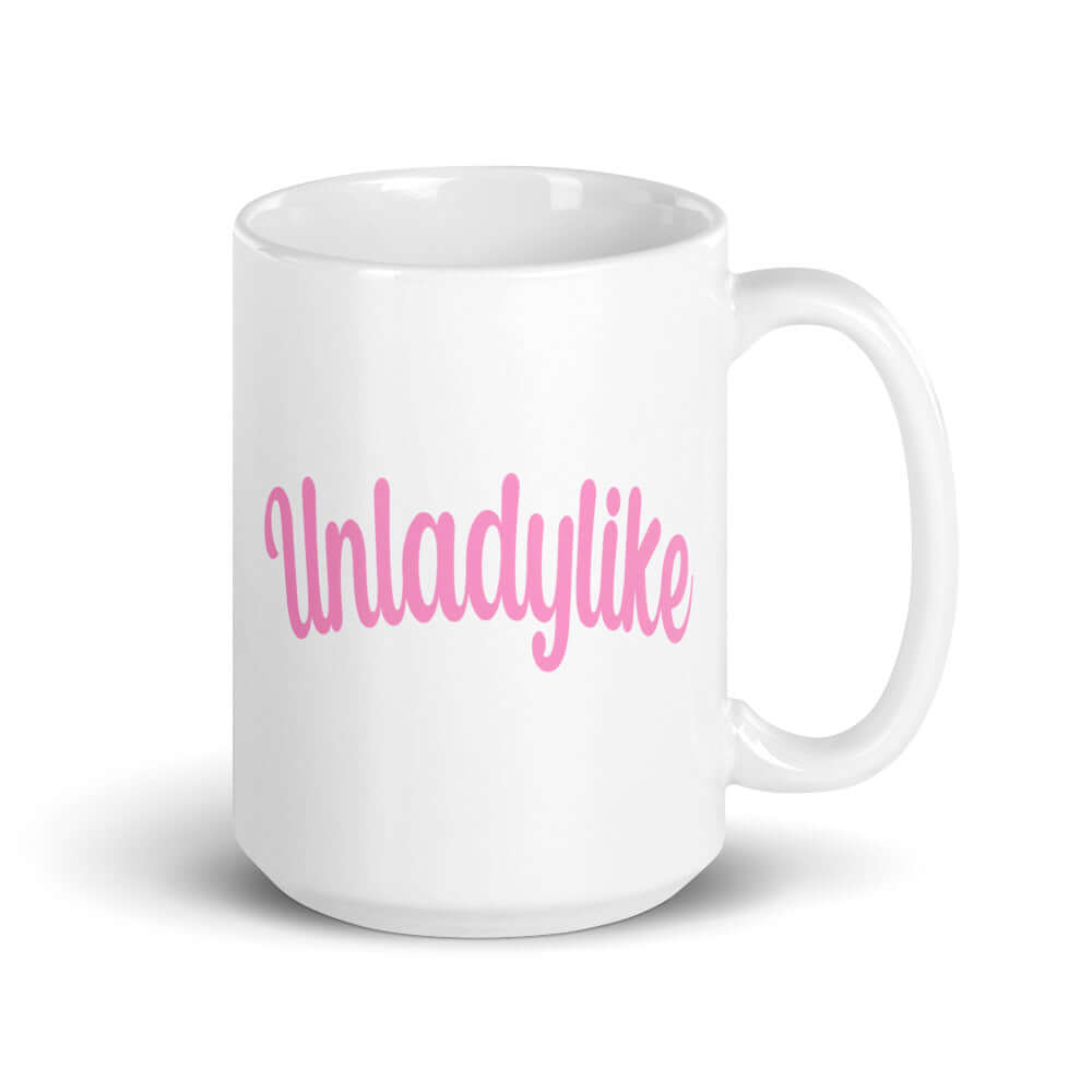 White ceramic coffee mug with the word Unladylike printed in pink on both sides.