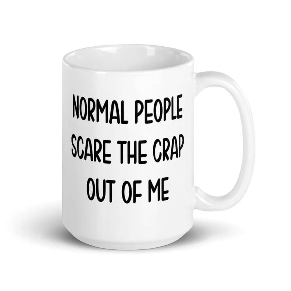 White ceramic coffee mug with the phrase Normal people scare the crap out of me printed on both sides.