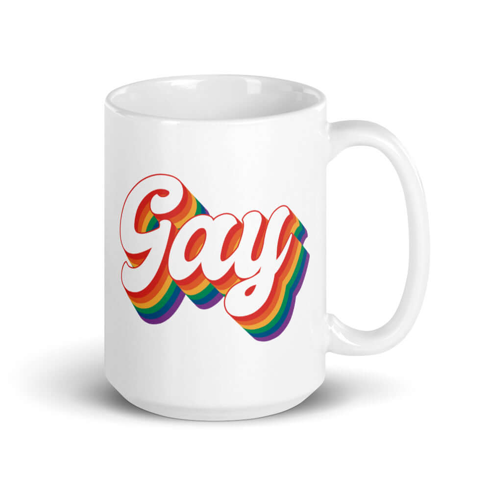 White ceramic mug with the word Gay printed on both sides. The word gay is outlined in rainbow.