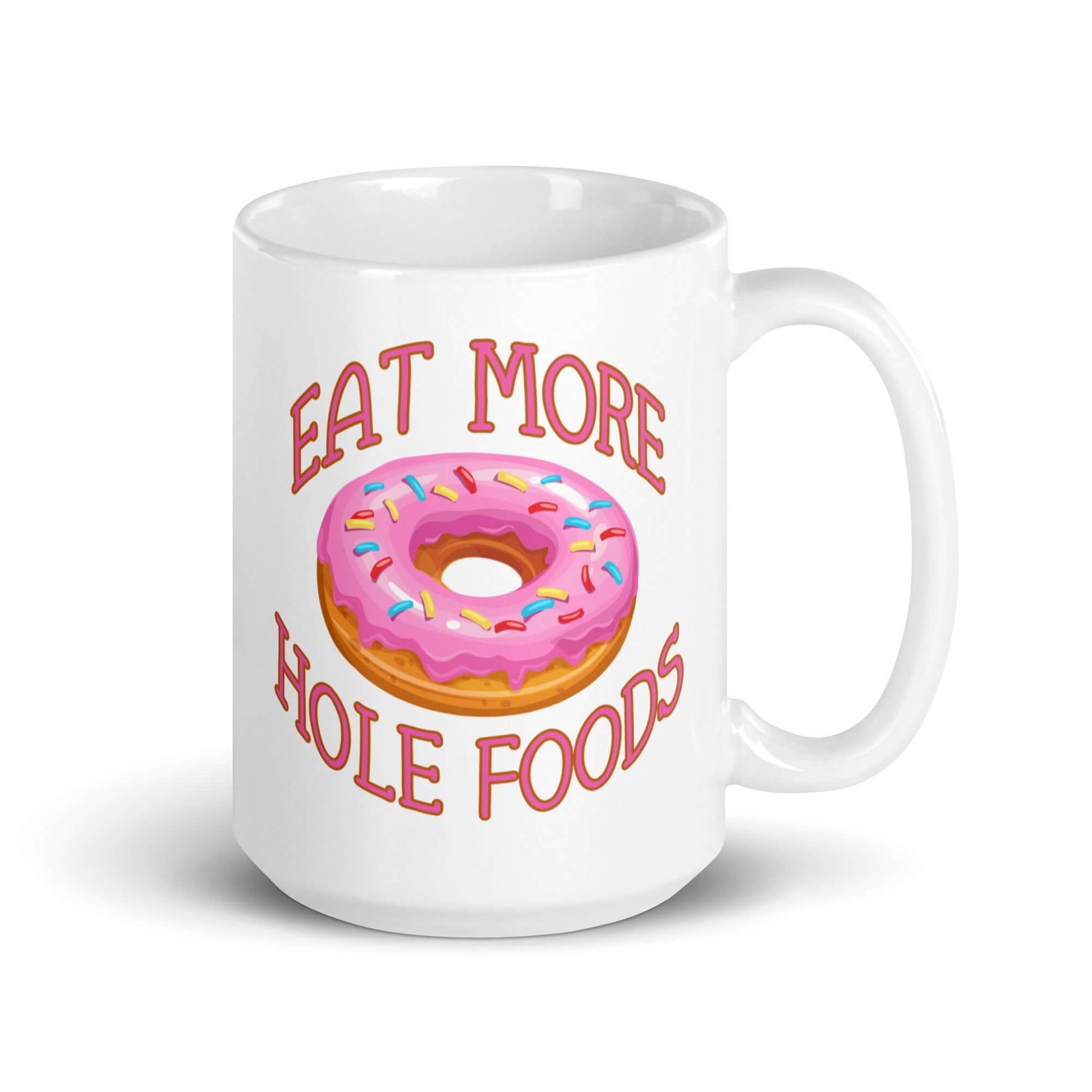 White coffee mug with an image of a donut with pink icing and sprinkles and the words Eat more hole foods printed on both sides.