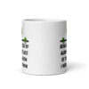 White ceramic mug with image of an alien and the words 'Being abducted by aliens might just be the vacation I need right now' printed on both sides.